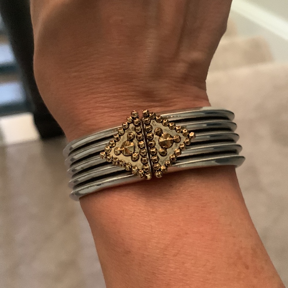 Heavy metal hinged bracelet in silver/ gold tones.